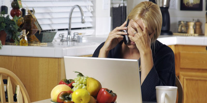 Image of person using laptop and phone