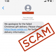 Screenshot of scam delivery text message with the bold, red word, 'SCAM' in all caps stamped on it. The simple text-only message reads 'We apologize for the failed Christmas gift delivery. Please check (and it has a link here that looks like it might come from Australia Post) for further delivery information.' There are no spelling, grammatical or punctuation errors.
