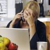 a lady on a phone call looking concerned and hands on her forehead